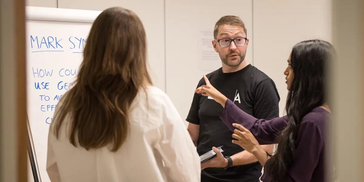 A photo of Mark Symes in conversation.