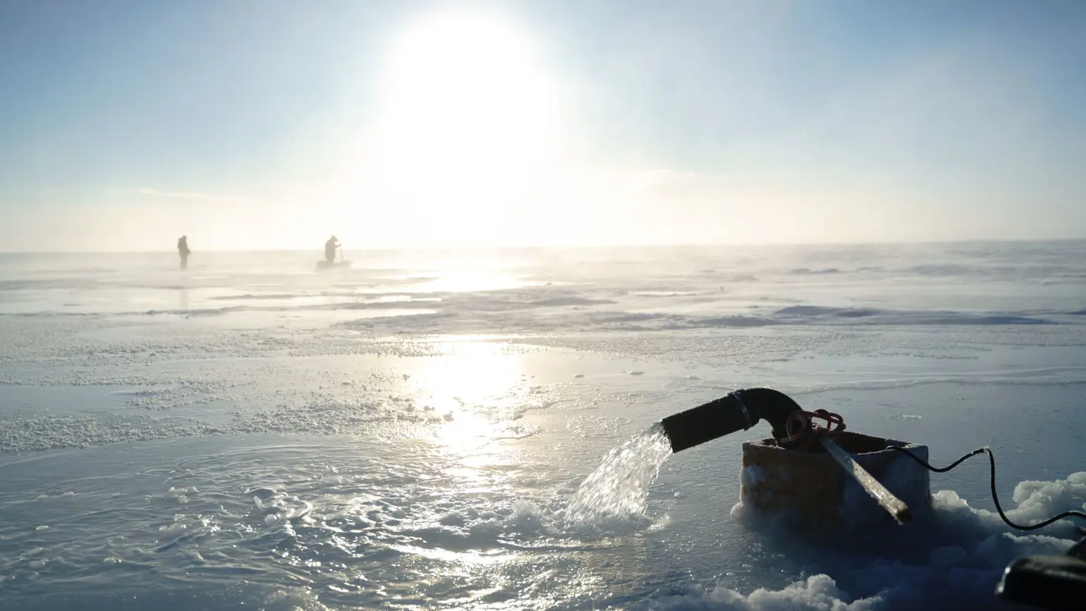 Real Ice team working on a pump in the ice fields” width=