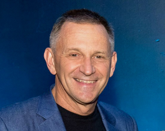 Headshot of Nick McKeown against a blue background