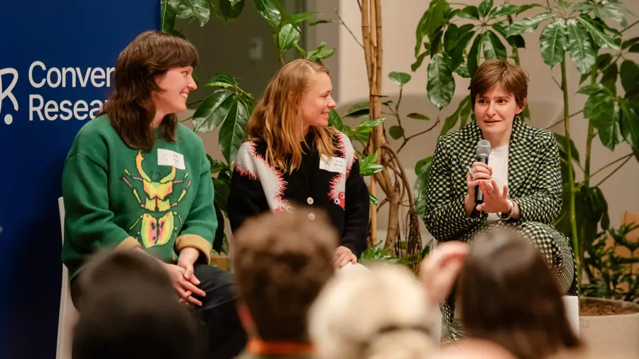 Kaja Wasik, Tosca Tindall, and Molly Blank in conversation on stage at an event.