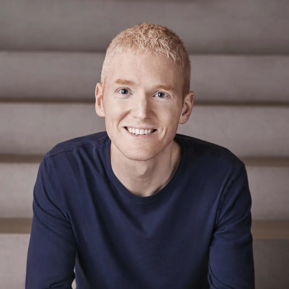 Photo of Patrick Collison sitting on some steps