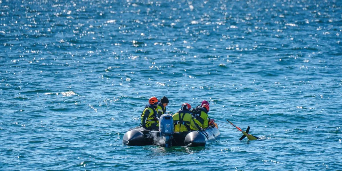 A team of scientists and crew members deploy an underwater glider in Antarctica.