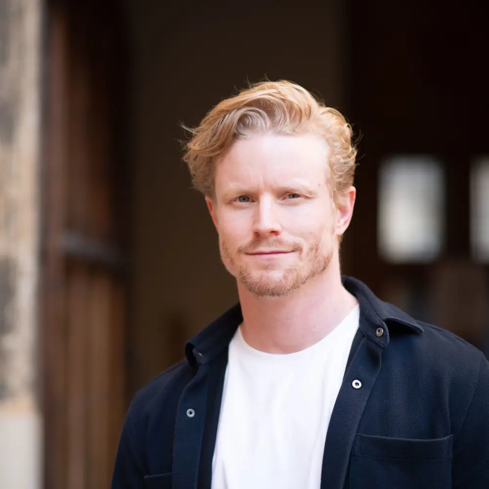 A photo of Mike Farrar standing outside a building