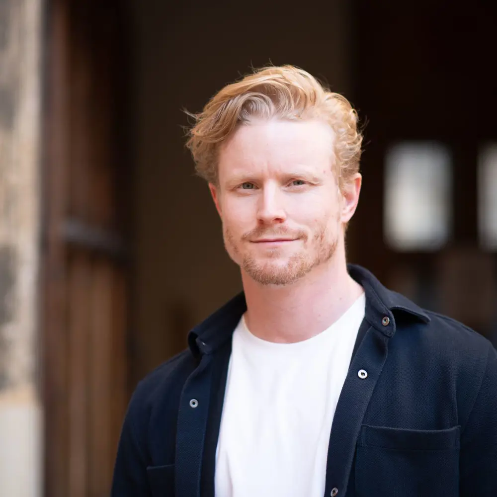 A photo of Mike Farrar standing outside a building