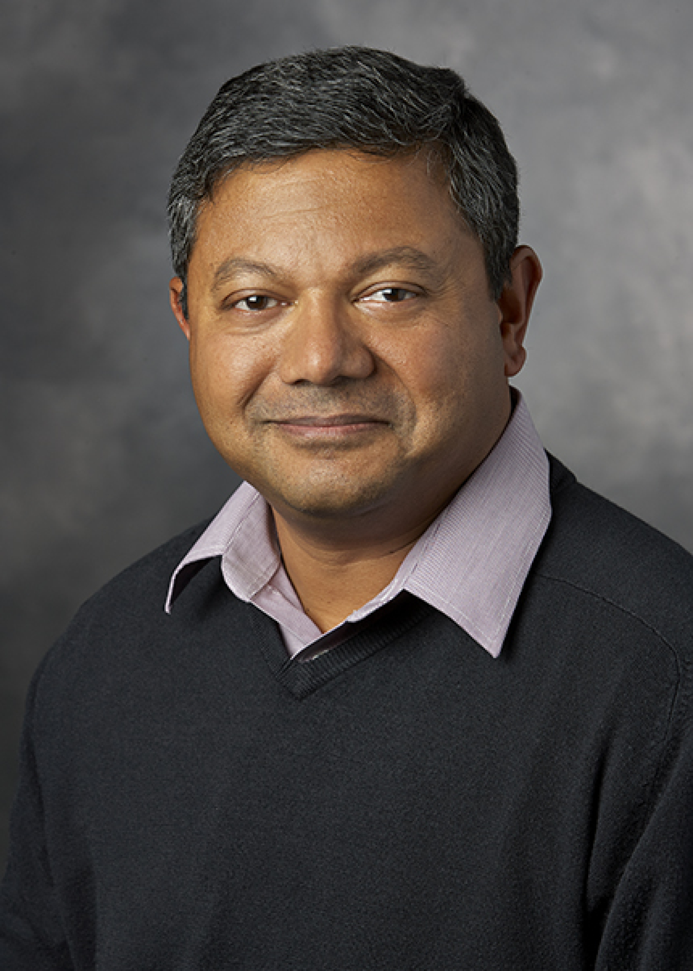 Headshot of Arun Majumdar against a grey background